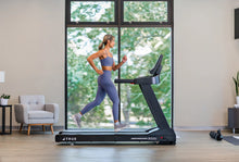 Load image into Gallery viewer, Woman running on a treadmill in a home setting - TRUE Performance 3000
